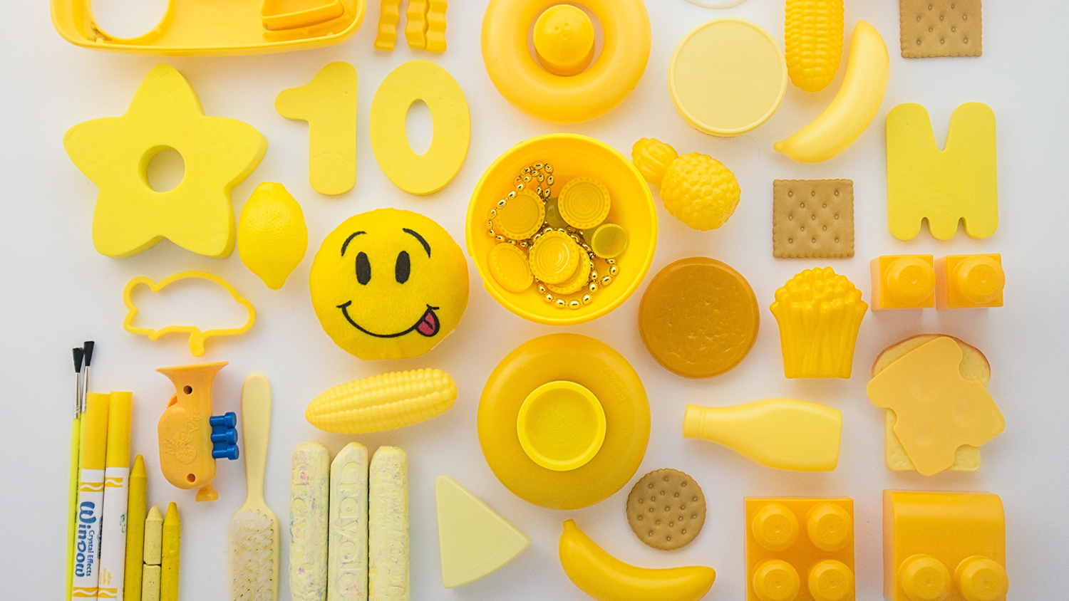 A variety of yellow plastic objects arranged in a grid.